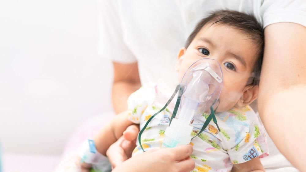 A baby boy treated for respiratory problem with vapor nebulize