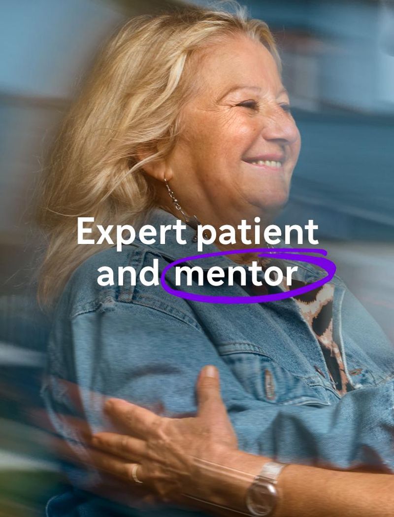 A smiling woman in a blue denim jacket reaches out to embrace another woman wearing glasses. Overlay text reads: "Expert patient and mentor."