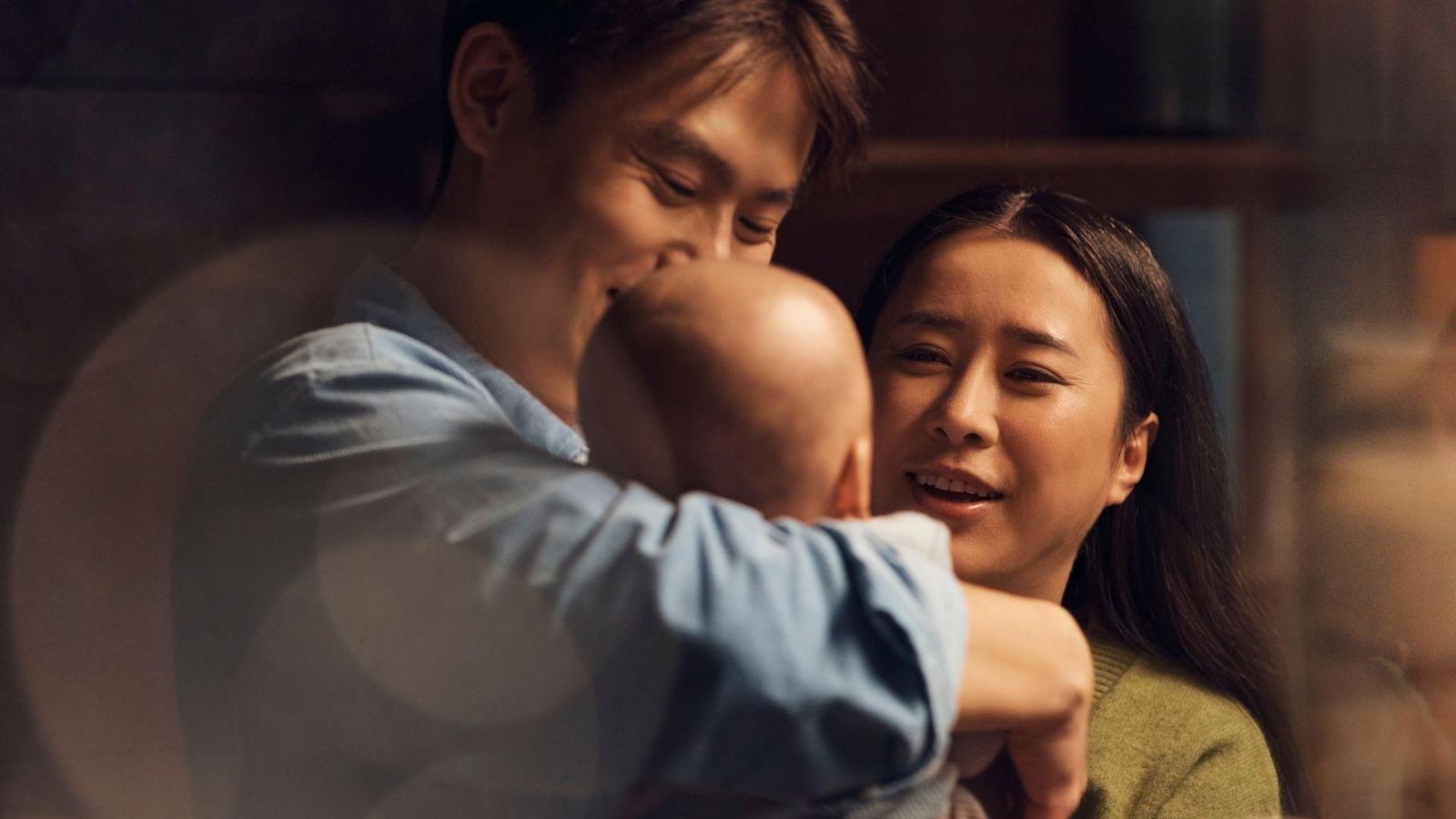 Parents at home holding their baby, who had experienced a severe RSV infection.