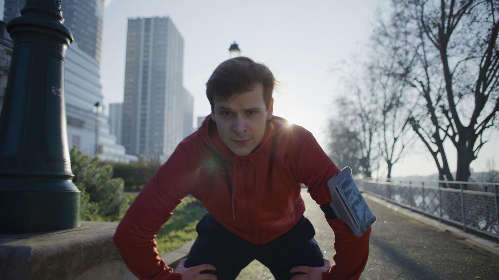 Pierre-Marie Robin, leans toward the camera with a serious look with short brown hair and an orange hoodie.