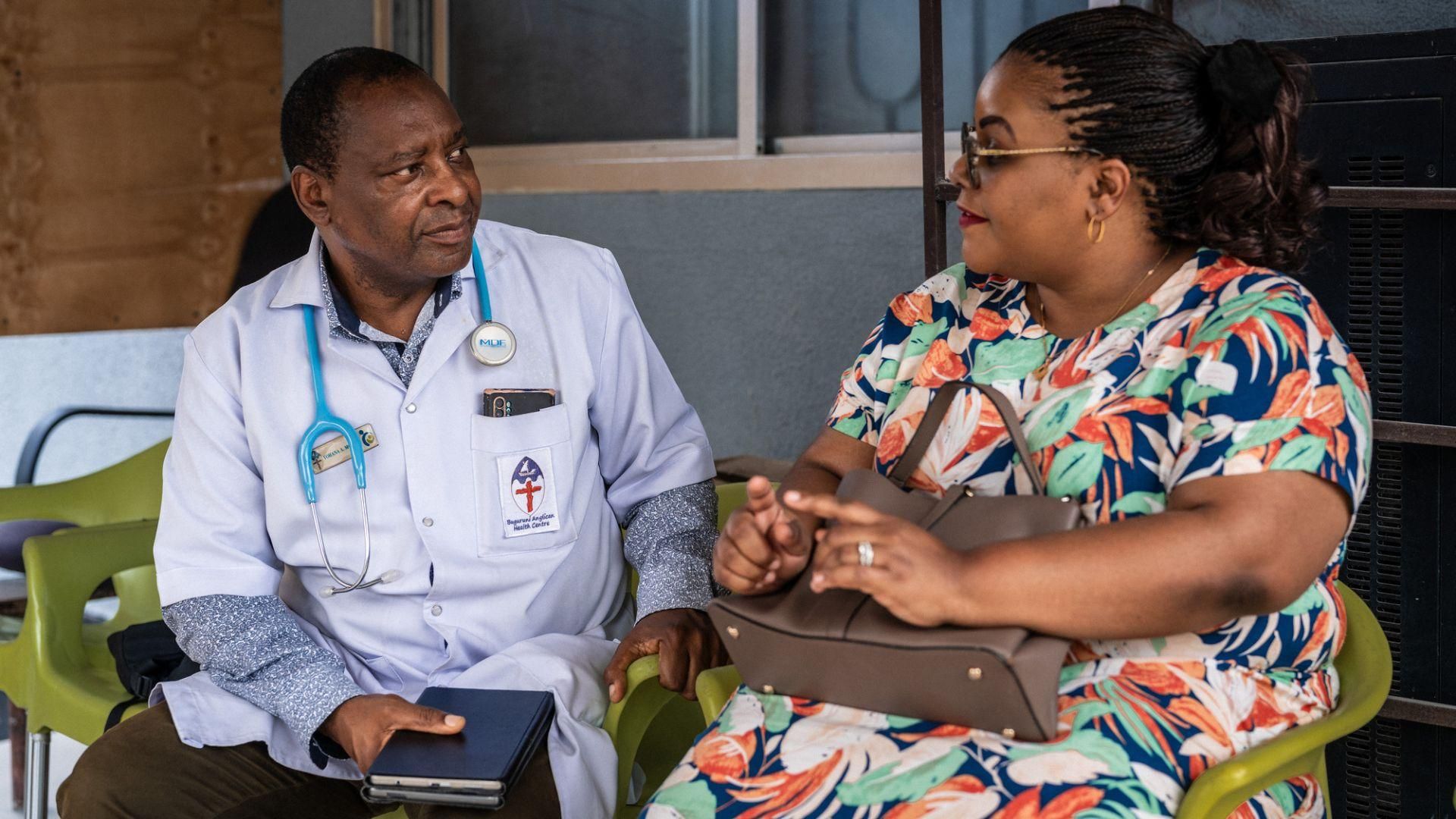 Dr Yohana Mokiwa with patient in Dar es Salaam, Tanzania, demonstrating Sanofi's sustainable pharmaceutical manufacturing commitment and equitable global health access in underserved communities.