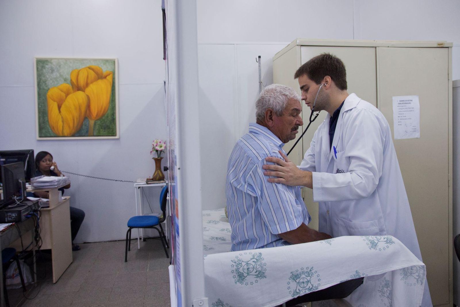 Healthcare provider listening to a patient’s chest with a stethoscope