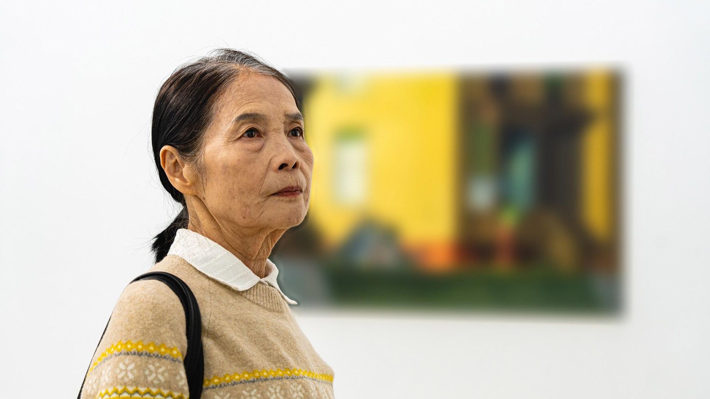 Chen Shaoqin working as a tour guide in an art gallery in Beijing, China