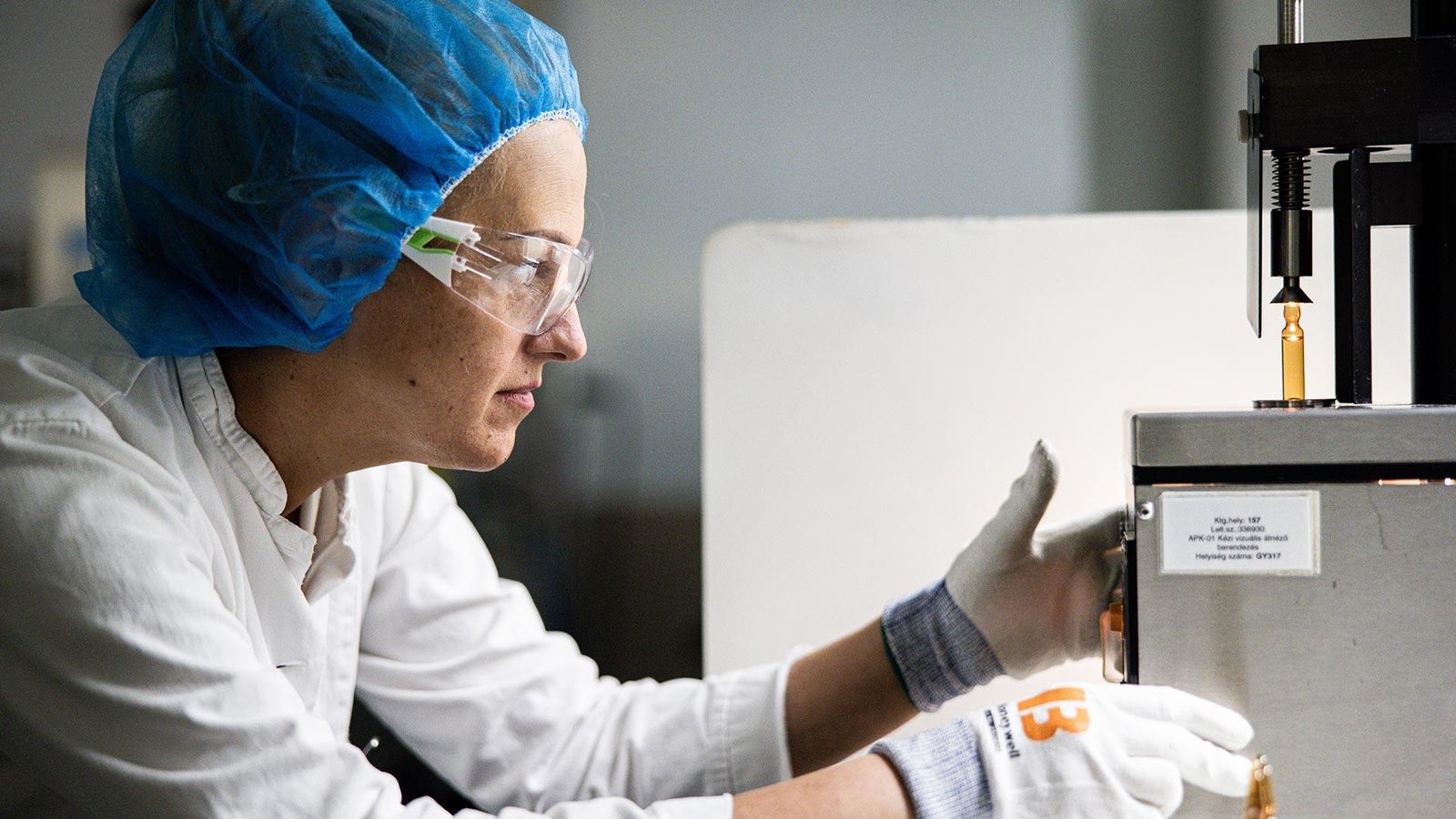 Gaborne Gajdos examines ampules at the Ampule production at the Sanofi plant in Csanyikvolgy, Hungary