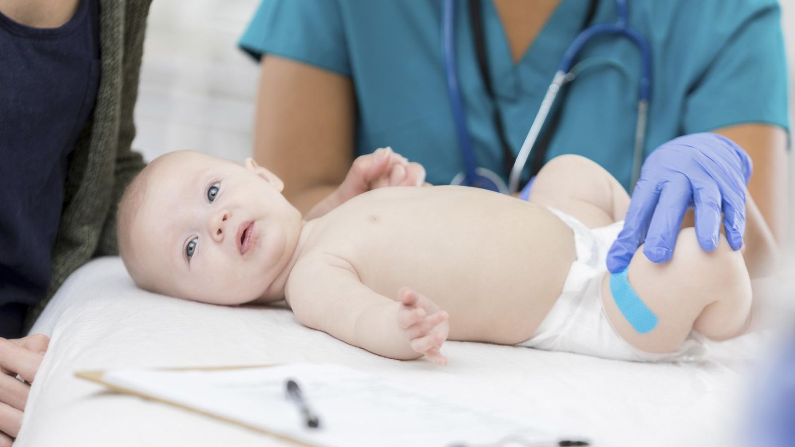 Newborn receives vaccines in the paediatrician's surgery 