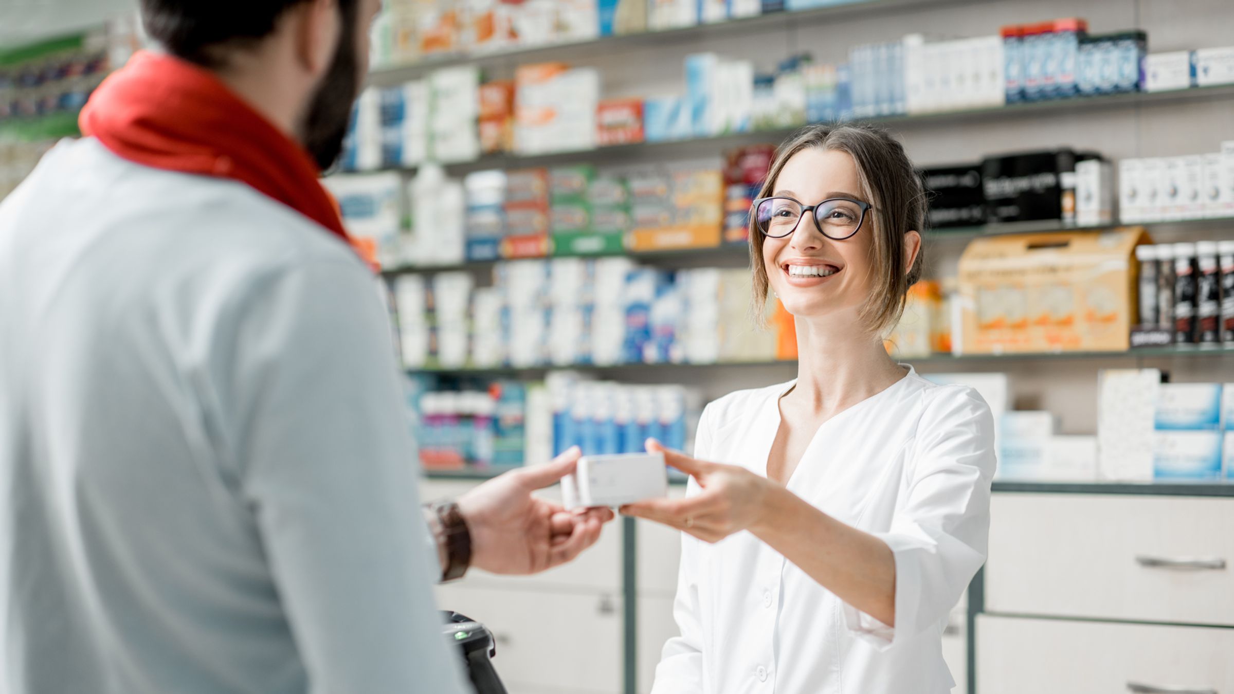 Pharmacist advises a type of medication to a customer